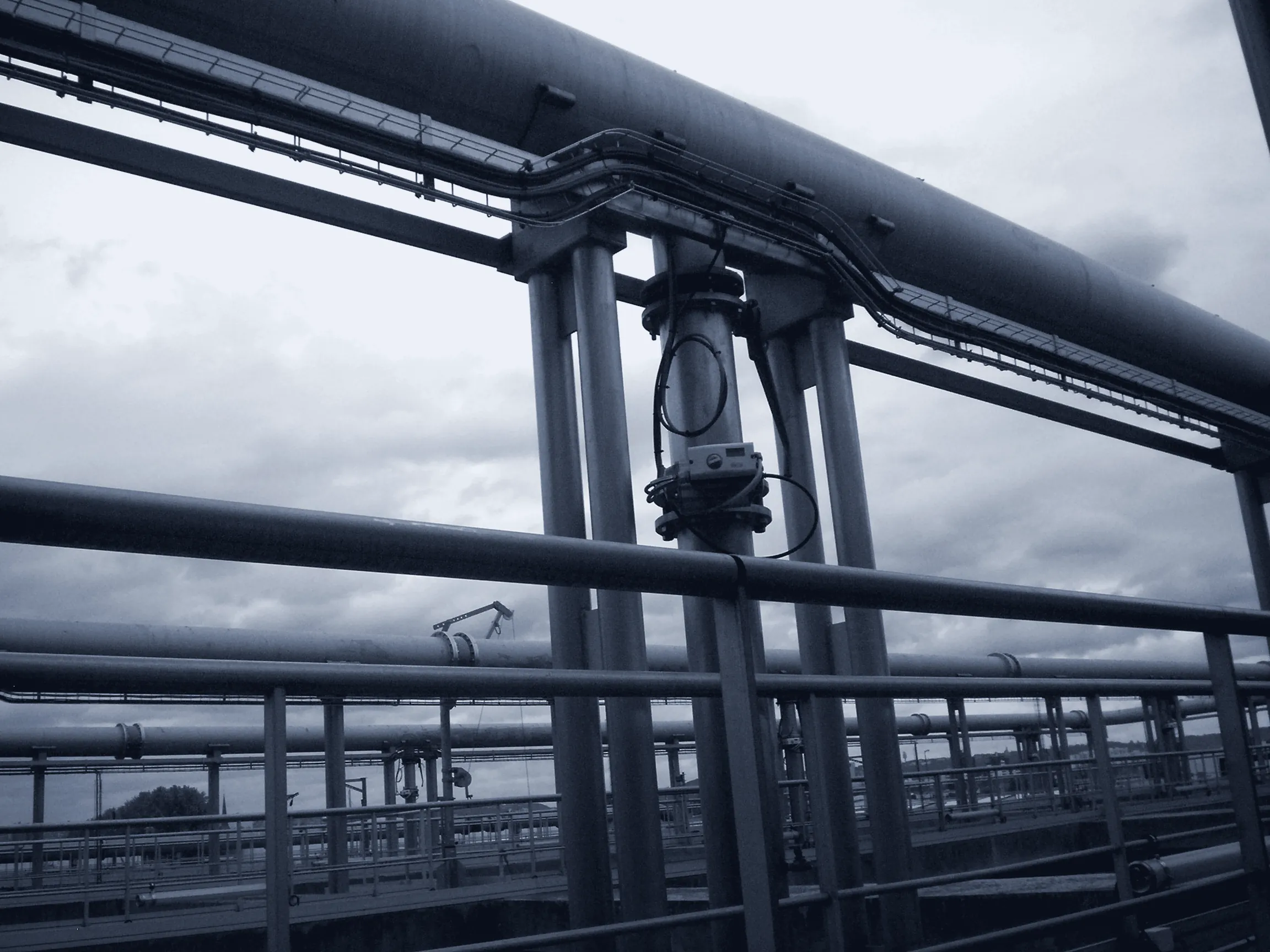 Pipe rack over industrial utility basins
