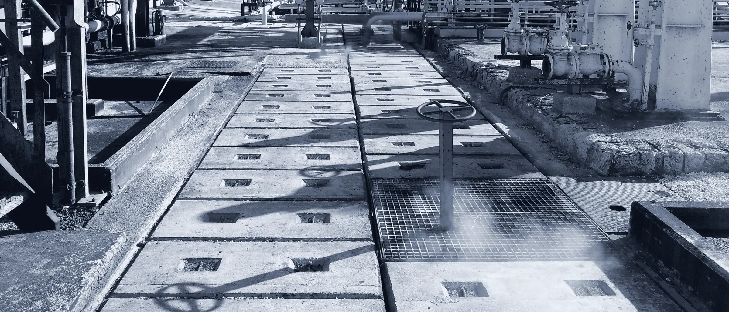 Valve and steam on an oil and gas plant walkway